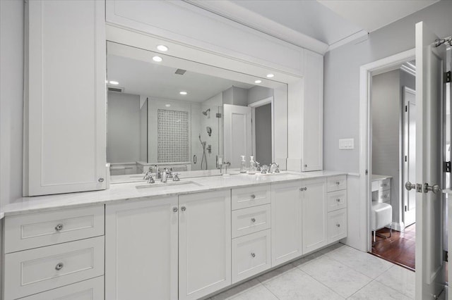 full bath featuring a sink, visible vents, tile patterned floors, double vanity, and a stall shower