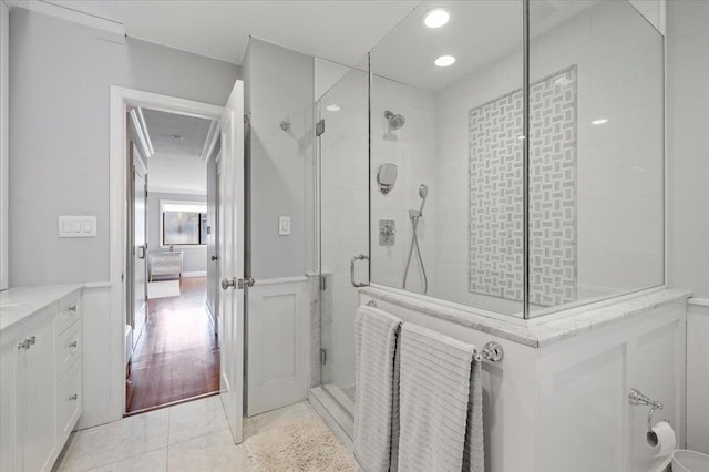 ensuite bathroom with a stall shower, tile patterned floors, ensuite bathroom, vanity, and recessed lighting