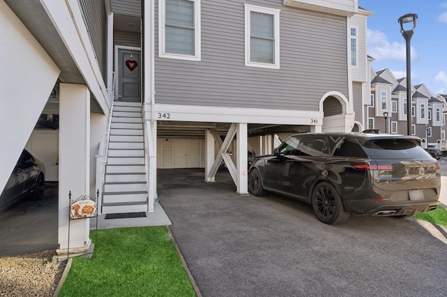 view of property exterior featuring stairs and a residential view