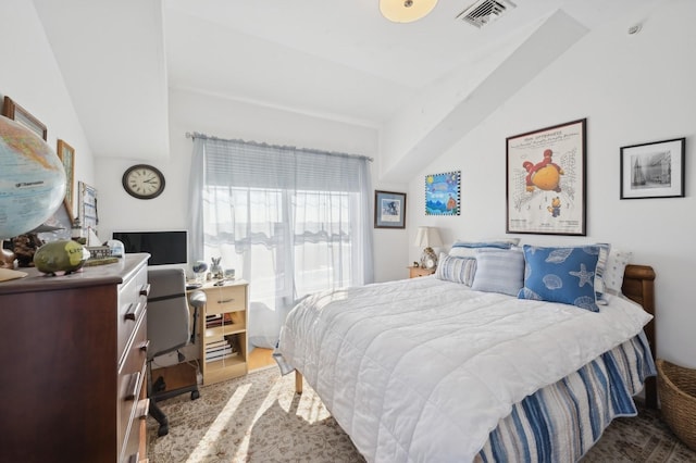 bedroom with vaulted ceiling and visible vents