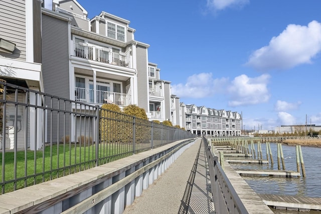 exterior space featuring a water view, fence, and a yard