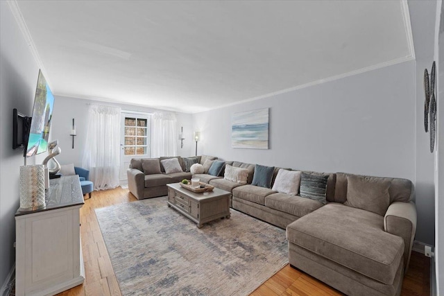 living room featuring light wood finished floors and ornamental molding