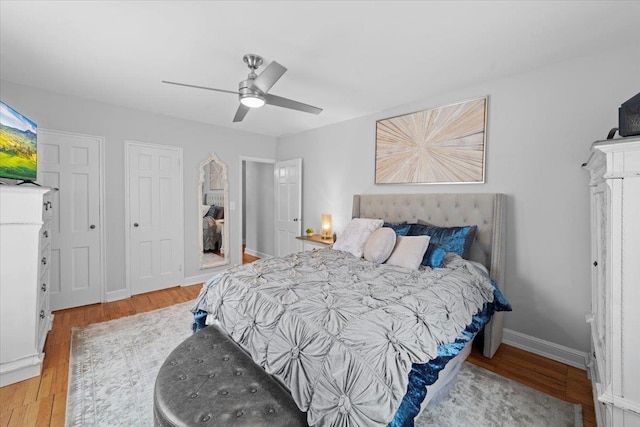 bedroom featuring ceiling fan, baseboards, and wood finished floors