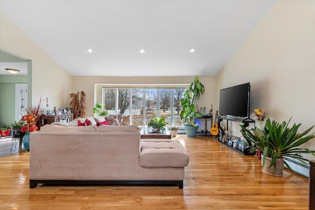 living room featuring light wood-type flooring, recessed lighting, and lofted ceiling