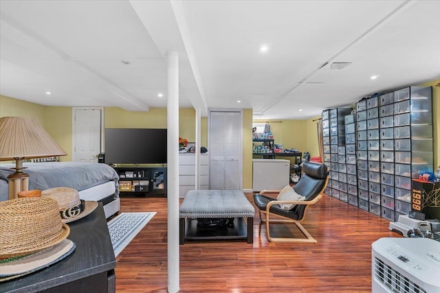 bedroom with wood finished floors and recessed lighting