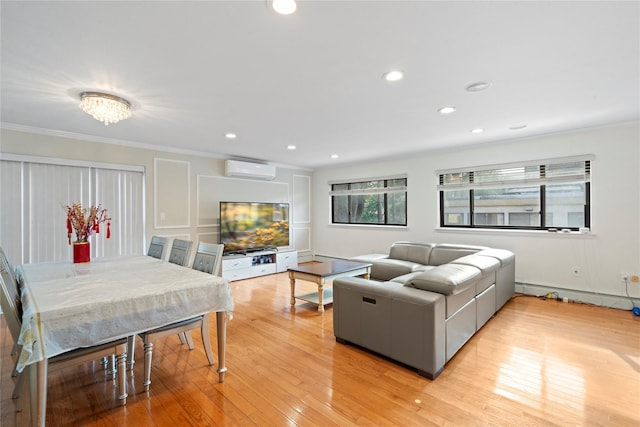 living area with light wood finished floors, recessed lighting, ornamental molding, and a wall mounted air conditioner