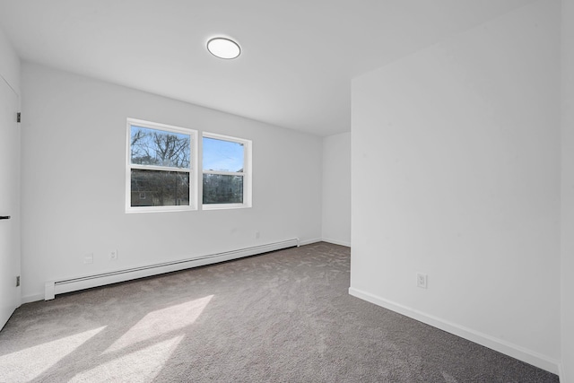 spare room with baseboards, a baseboard heating unit, and carpet flooring