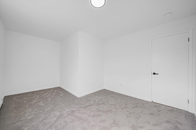 additional living space featuring carpet floors and baseboards