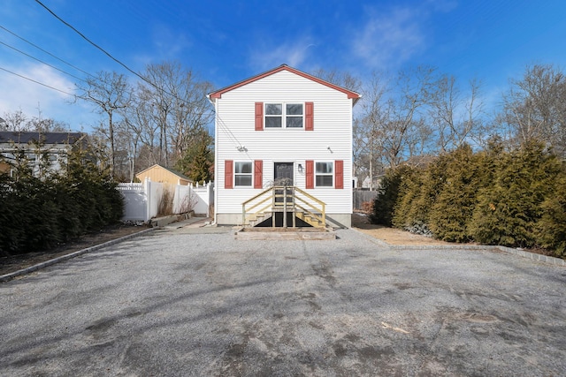 view of front of home featuring fence