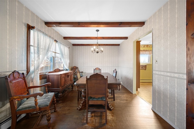 dining room featuring a notable chandelier, dark wood-style flooring, baseboard heating, and wallpapered walls