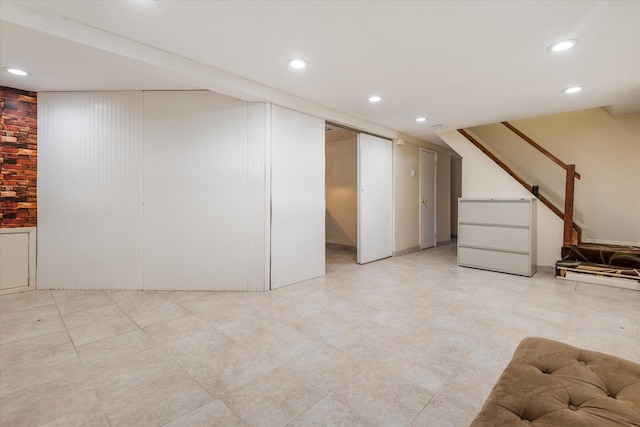 finished basement featuring recessed lighting and stairway