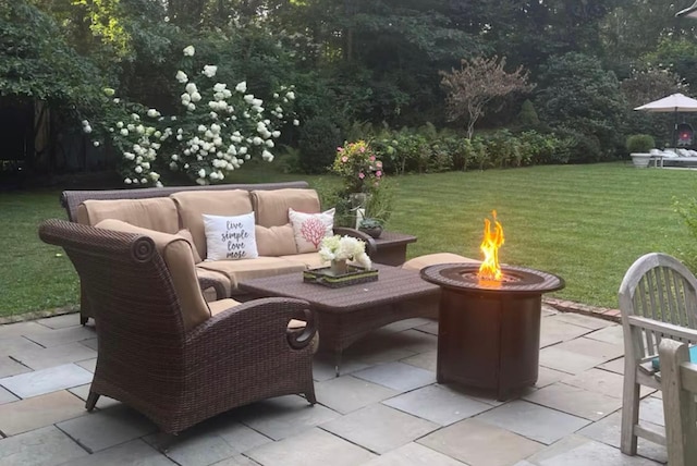 view of patio / terrace with an outdoor living space with a fire pit