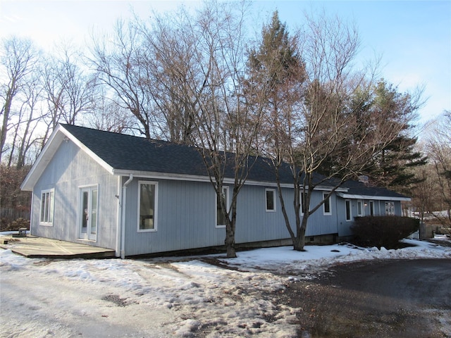 view of front of home with a wooden deck and french doors