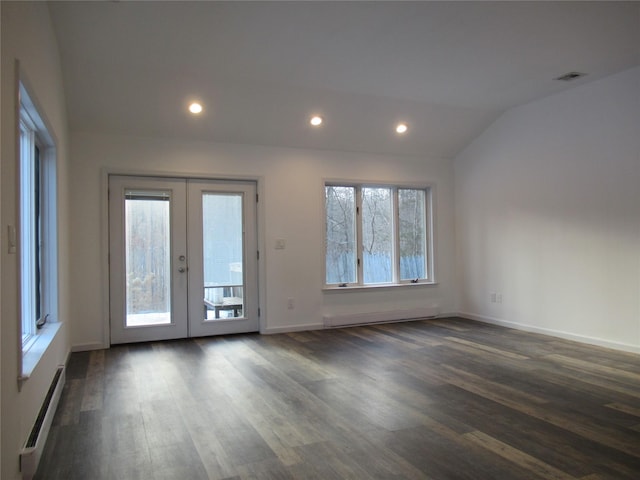 spare room featuring dark wood-type flooring, vaulted ceiling, baseboard heating, french doors, and recessed lighting