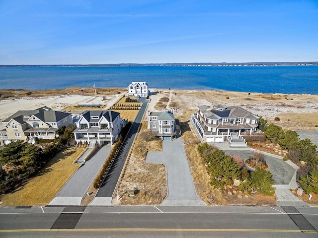 birds eye view of property with a water view and a residential view