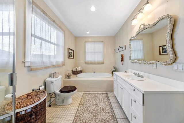 bathroom with toilet, recessed lighting, vanity, a bath, and tile patterned floors