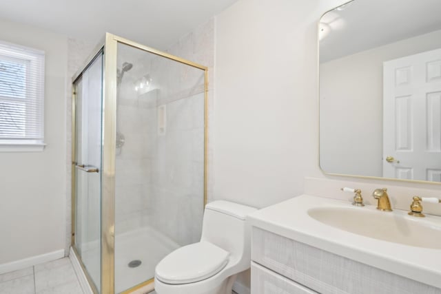 bathroom featuring a stall shower, vanity, toilet, and tile patterned floors