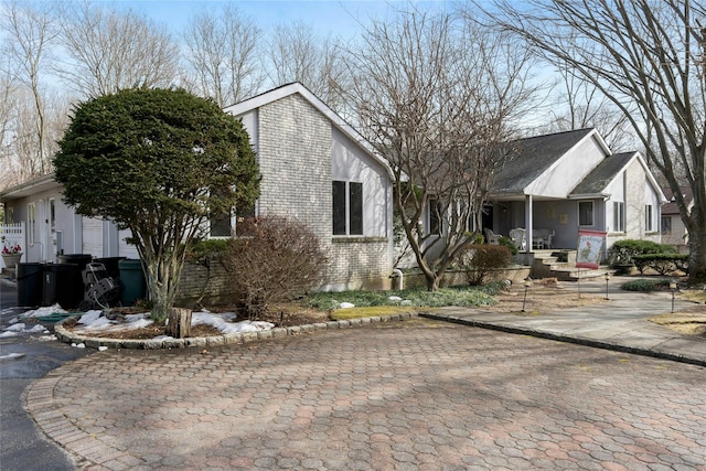 view of front of house featuring a porch and brick siding