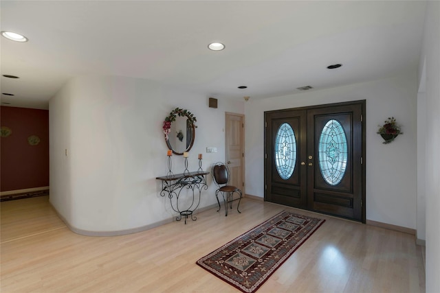 foyer entrance with recessed lighting, french doors, visible vents, and wood finished floors