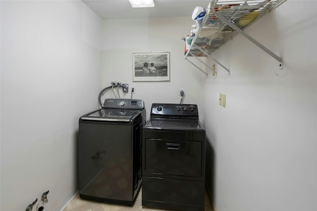 laundry room with laundry area, baseboards, and washer and dryer