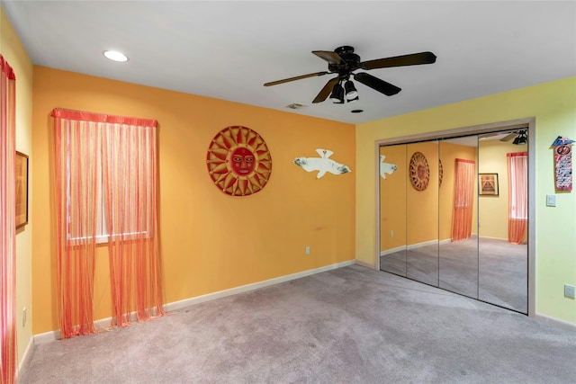 unfurnished bedroom with carpet, visible vents, ceiling fan, and baseboards