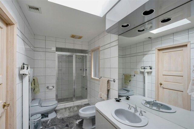 full bath with toilet, visible vents, tile walls, a shower stall, and a bidet