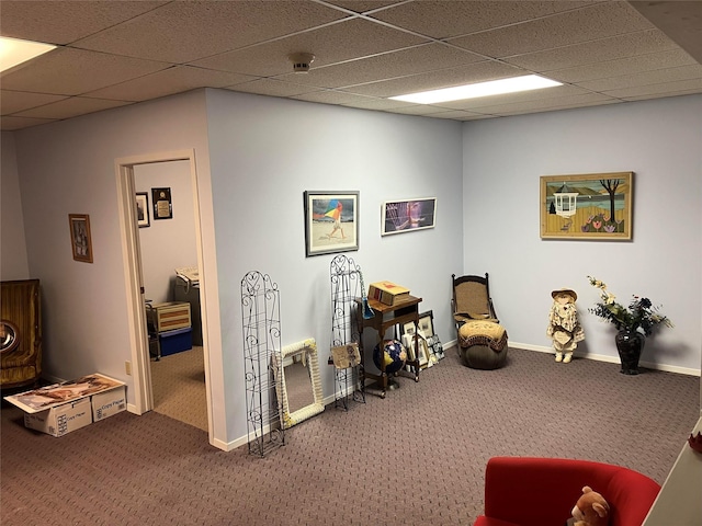 interior space with carpet floors, baseboards, and a paneled ceiling