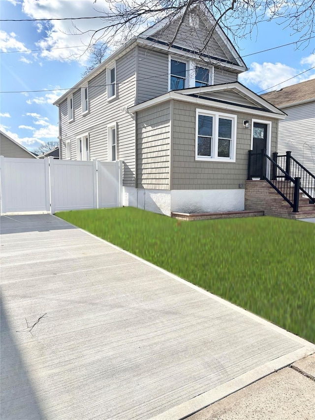 view of front of house with a front lawn and fence