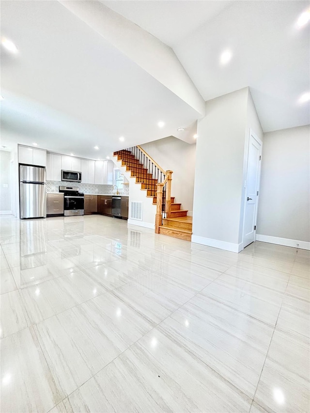 unfurnished living room with stairs, recessed lighting, baseboards, and visible vents