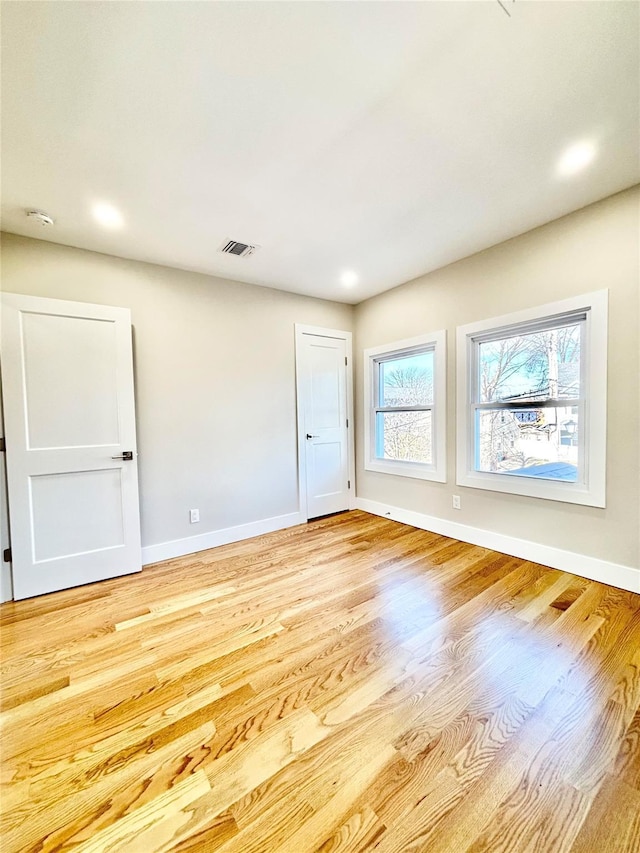 spare room featuring visible vents, recessed lighting, light wood-style floors, and baseboards