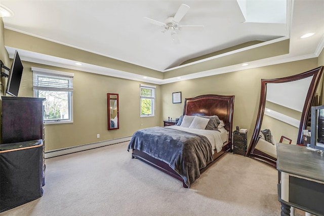 bedroom featuring a baseboard radiator, multiple windows, a tray ceiling, and light colored carpet