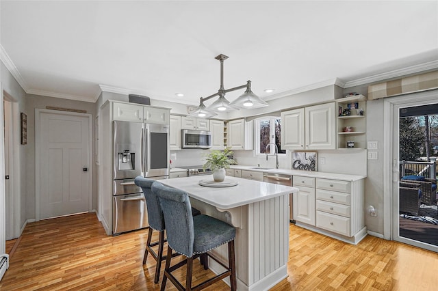 kitchen with a kitchen island, hanging light fixtures, stainless steel appliances, light countertops, and open shelves