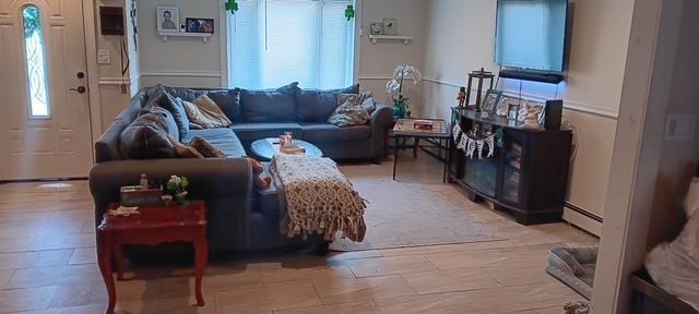 living room with a wealth of natural light and a baseboard radiator