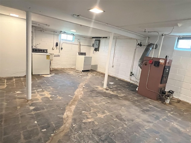 below grade area with electric panel and washer / clothes dryer