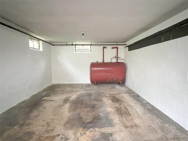 below grade area with heating fuel and concrete block wall