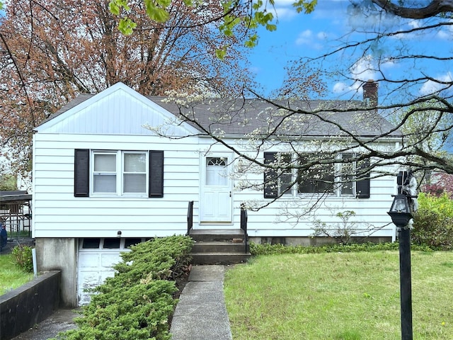bungalow-style home featuring an attached garage, a chimney, and a front lawn