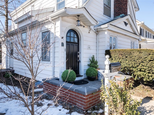 view of snow covered property entrance