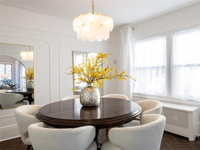 dining room featuring arched walkways, radiator heating unit, and an inviting chandelier