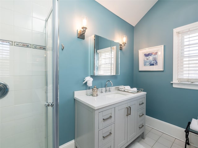 full bathroom featuring baseboards, lofted ceiling, tile patterned floors, a tile shower, and vanity