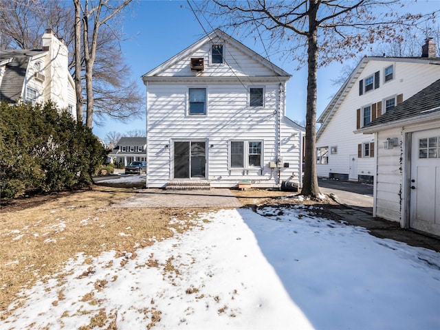 snow covered property featuring entry steps