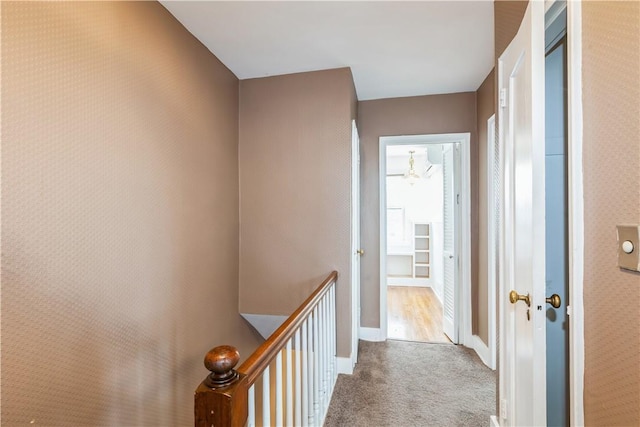 corridor with carpet flooring and baseboards