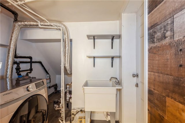 laundry room featuring laundry area, a sink, and washer / dryer