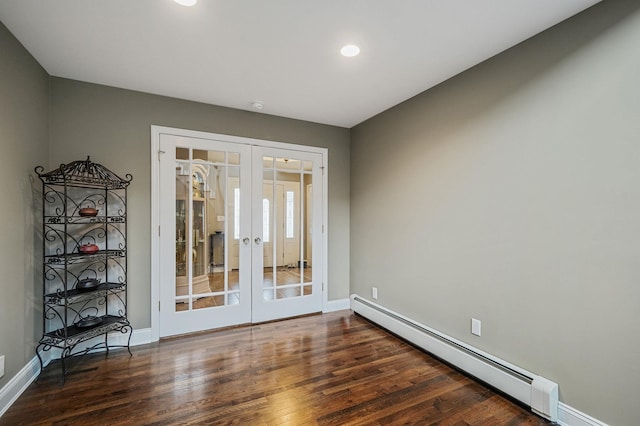 empty room featuring dark wood-style floors, french doors, recessed lighting, a baseboard heating unit, and baseboards