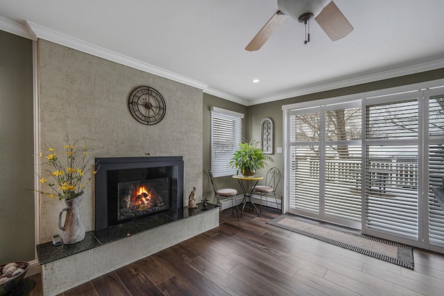 unfurnished room featuring recessed lighting, a premium fireplace, ornamental molding, ceiling fan, and wood finished floors