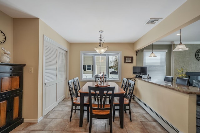 dining space with visible vents, a baseboard heating unit, and baseboards