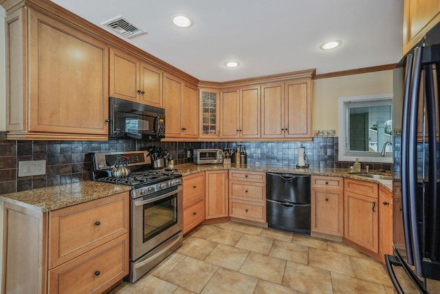 kitchen featuring glass insert cabinets, visible vents, light stone counters, and black appliances