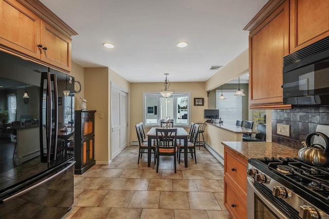 kitchen with stone countertops, brown cabinets, and black appliances