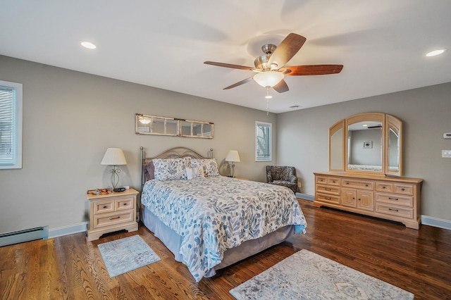 bedroom with baseboard heating, baseboards, dark wood finished floors, and recessed lighting