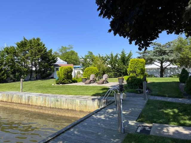 view of dock featuring a yard