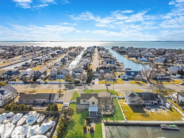 drone / aerial view featuring a water view and a residential view